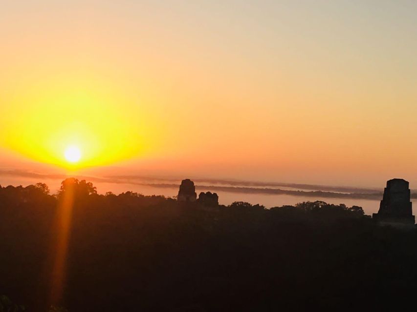 From Flores: Tikal Sunrise Archaeological Tour - Waiting for sunrise at Temple IV